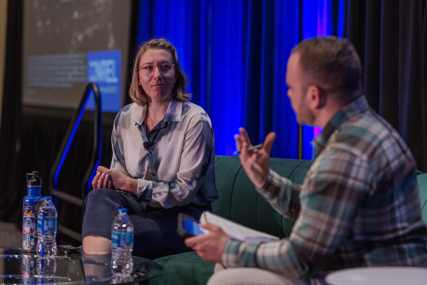 Taylor Uekert in conversation on stage at a sustainability conference panel